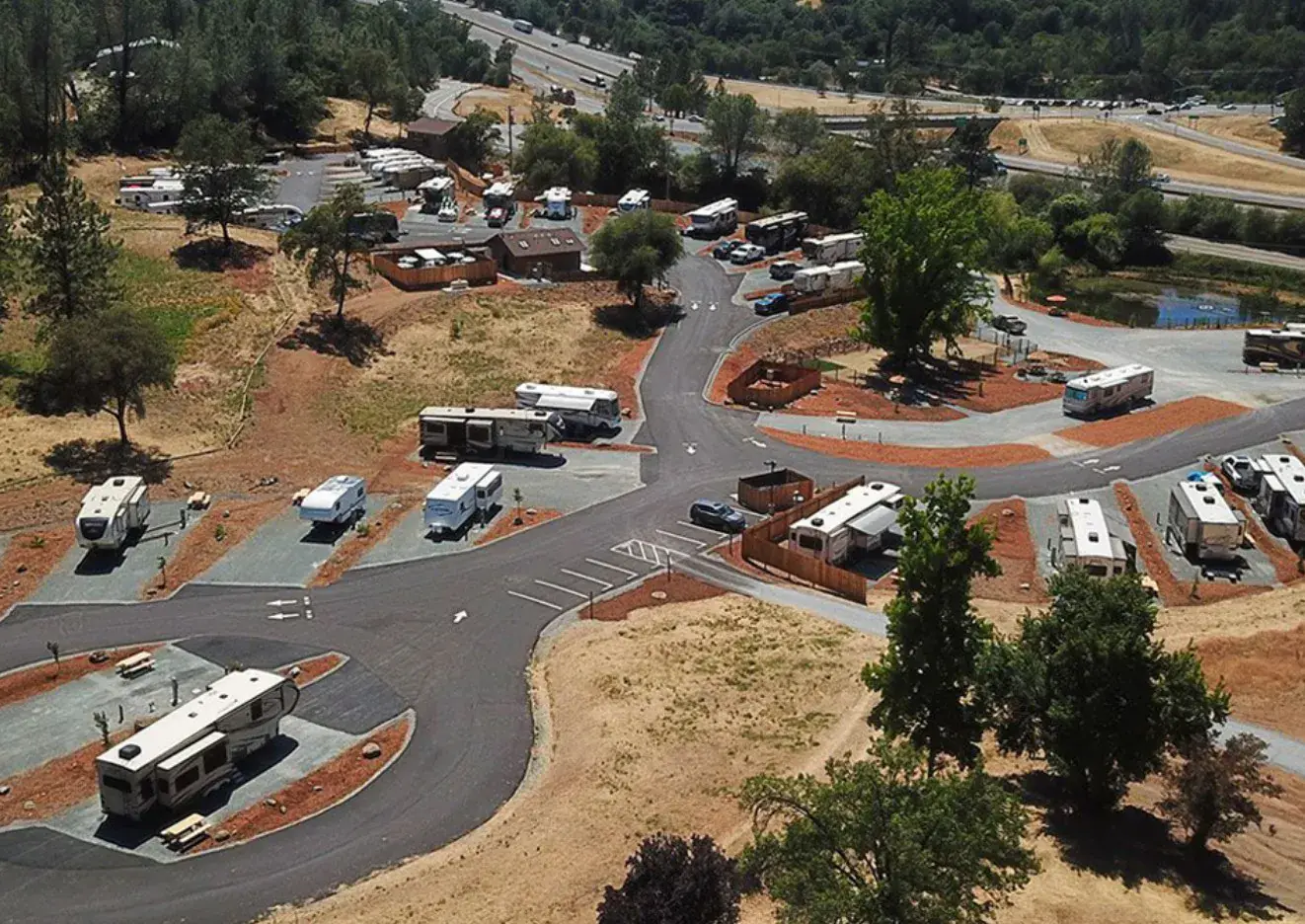 Motorhomes on spacious sites at Auburn RV Resort with golden Sierra foothills at sunset